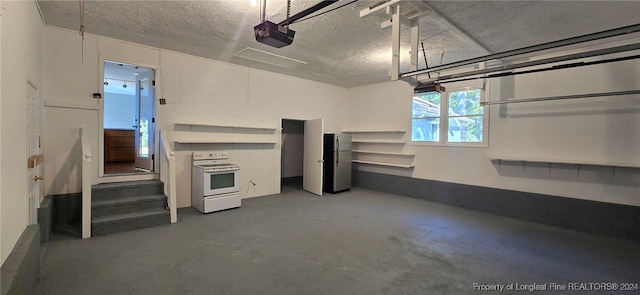 garage featuring a garage door opener and stainless steel refrigerator