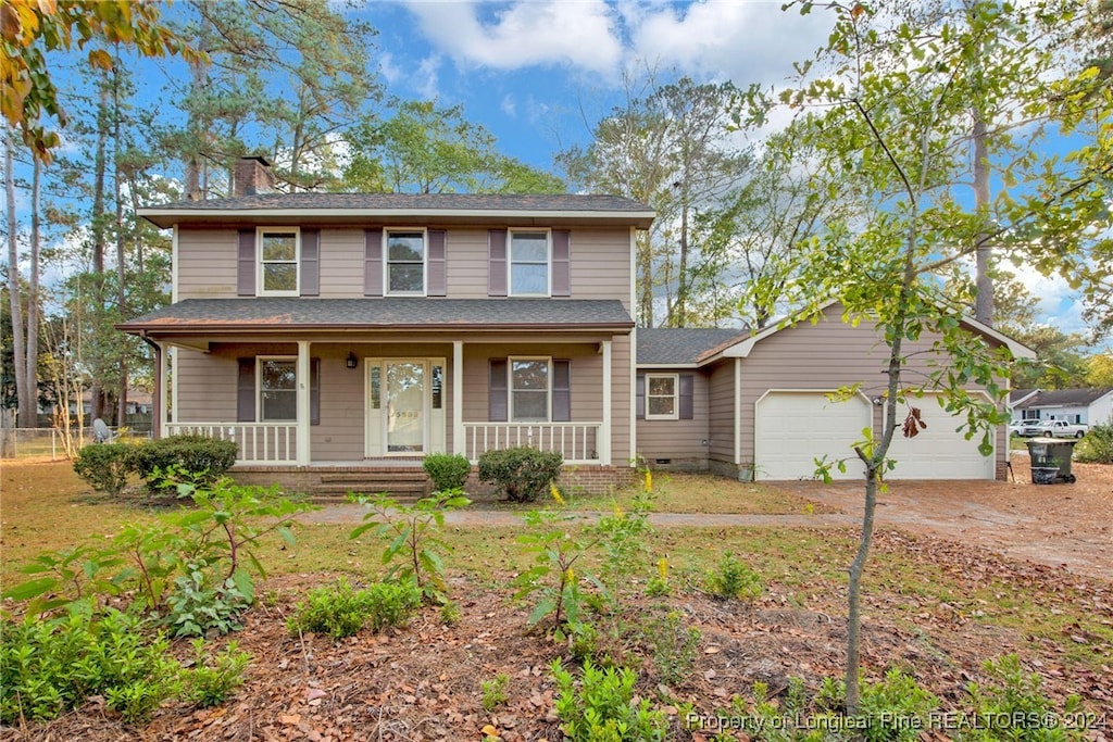 view of front of home featuring covered porch and a garage