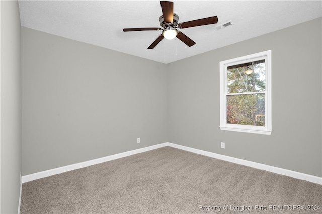 empty room featuring carpet, a textured ceiling, and ceiling fan