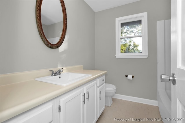 bathroom with tile patterned floors, vanity, and toilet