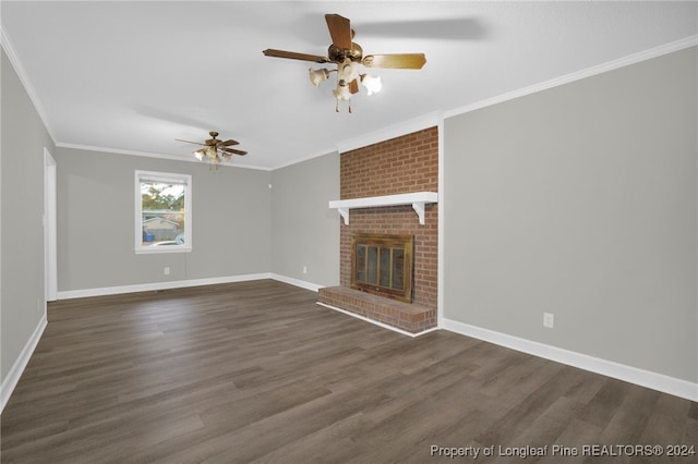 unfurnished living room featuring ceiling fan, crown molding, dark wood-type flooring, and a brick fireplace