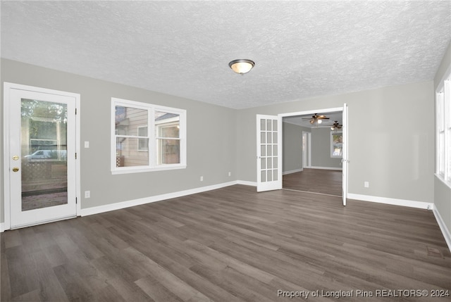 interior space featuring french doors, a textured ceiling, dark hardwood / wood-style floors, and ceiling fan