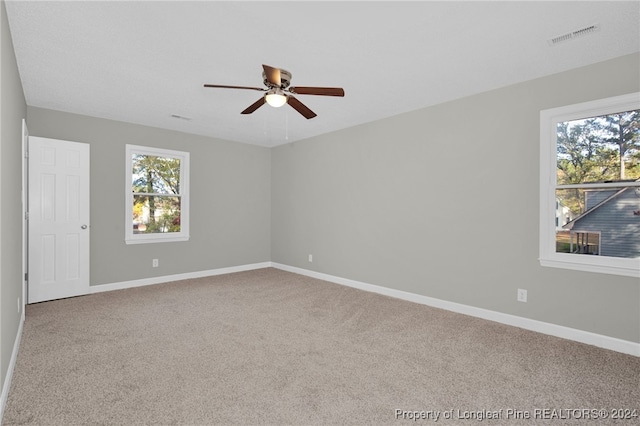 unfurnished room with ceiling fan and carpet floors