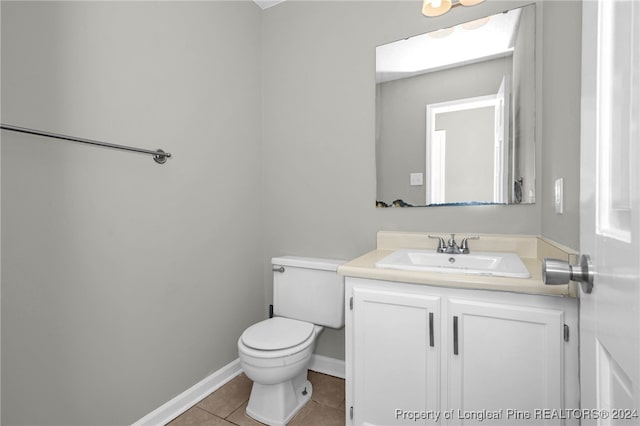 bathroom featuring a skylight, tile patterned flooring, vanity, and toilet