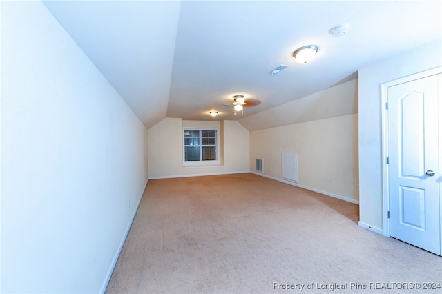 additional living space with light carpet and lofted ceiling