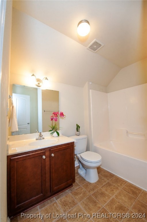 full bathroom with shower / bathing tub combination, vanity, lofted ceiling, tile patterned flooring, and toilet