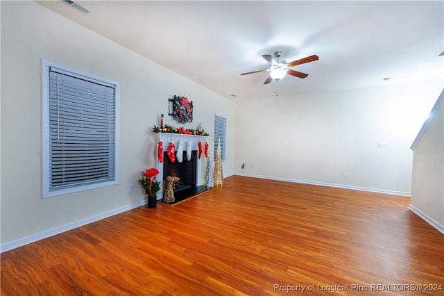 living room with ceiling fan and hardwood / wood-style flooring