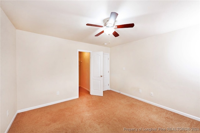 carpeted empty room featuring ceiling fan