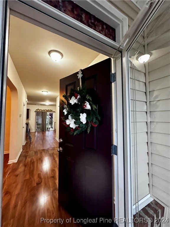 hallway with hardwood / wood-style floors