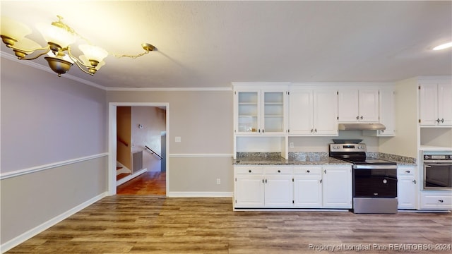 kitchen featuring light stone countertops, ornamental molding, light hardwood / wood-style floors, white cabinetry, and stainless steel appliances