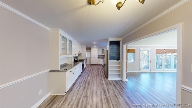 kitchen featuring white cabinets, hardwood / wood-style floors, and stainless steel electric range