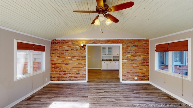 empty room with hardwood / wood-style floors, plenty of natural light, and ornamental molding