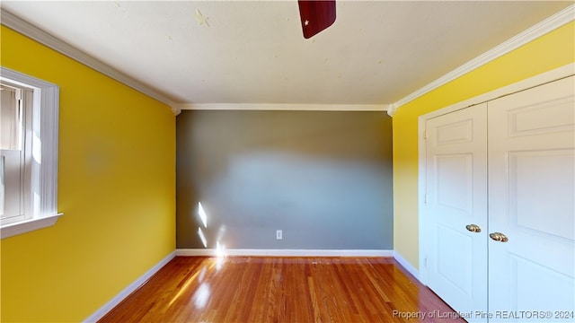 spare room featuring crown molding and hardwood / wood-style flooring