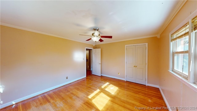 unfurnished bedroom featuring wood-type flooring, ceiling fan, and ornamental molding