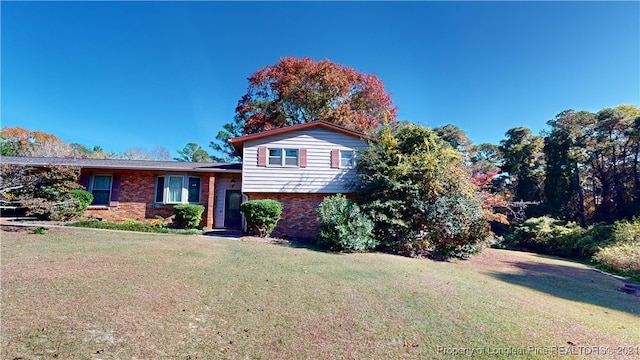 split level home with a front lawn