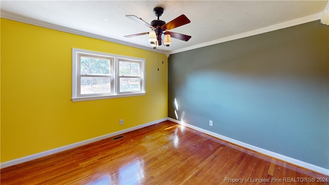 spare room featuring crown molding, hardwood / wood-style floors, and ceiling fan