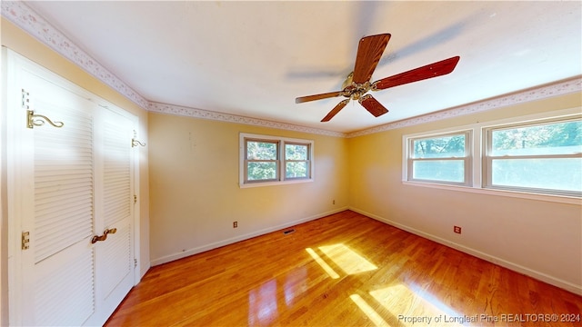 unfurnished bedroom with ceiling fan, a closet, and light hardwood / wood-style flooring