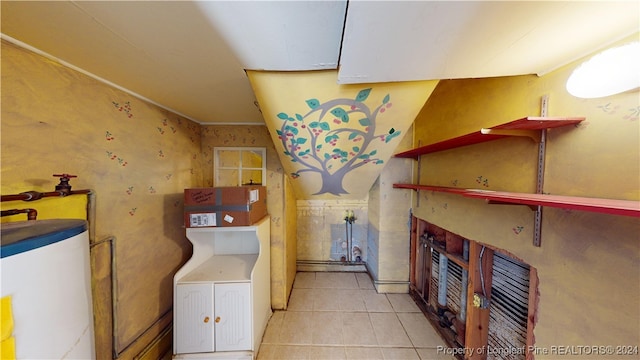 washroom featuring light tile patterned floors and water heater