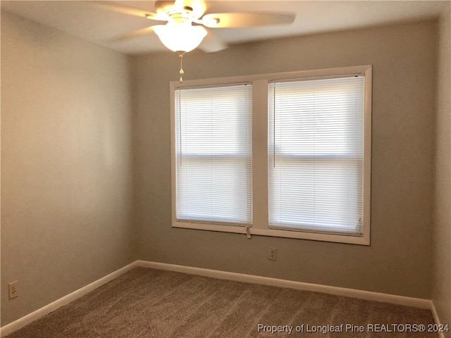 spare room with carpet and ceiling fan