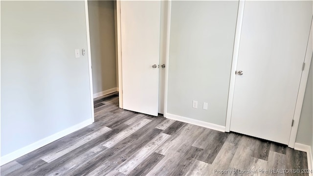 unfurnished bedroom featuring wood-type flooring