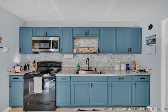 kitchen with black electric range, a textured ceiling, blue cabinetry, and sink