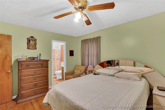 bedroom featuring ensuite bathroom, ceiling fan, a textured ceiling, and light wood-type flooring