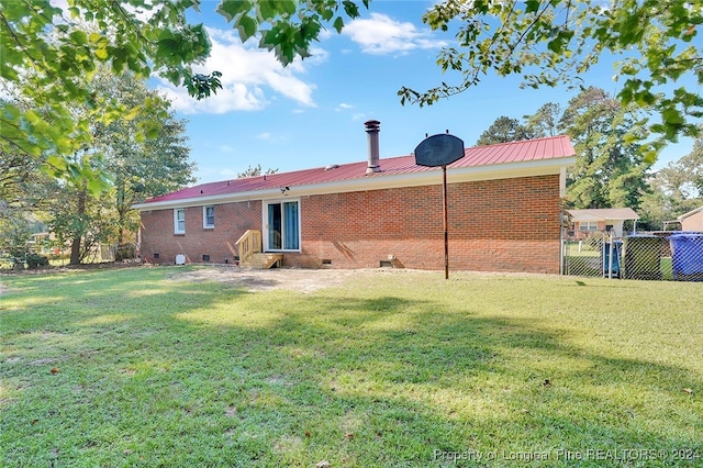 rear view of house with a lawn