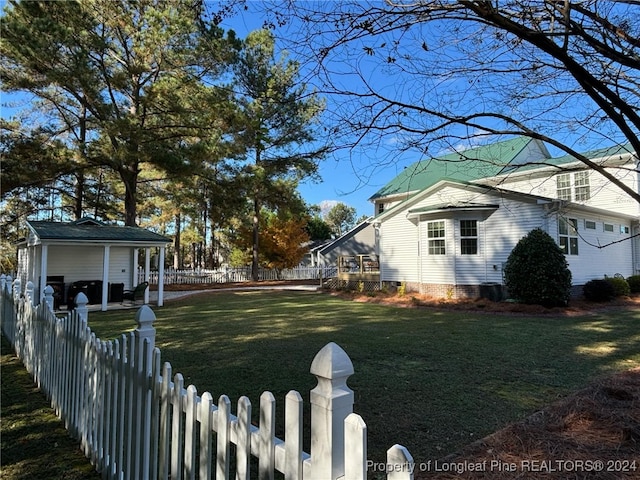 view of side of property with a lawn