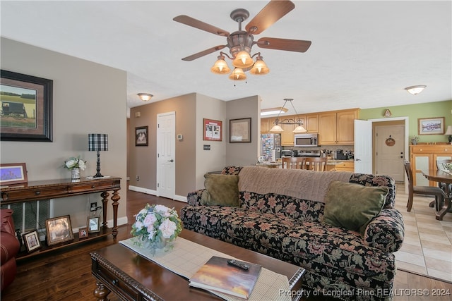 living room featuring light hardwood / wood-style floors and ceiling fan