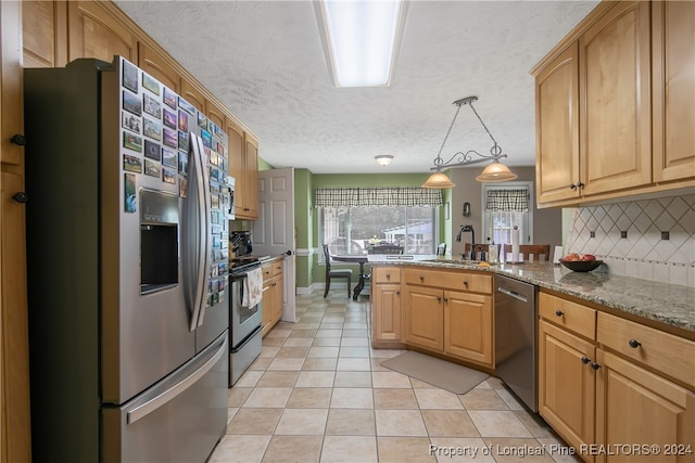 kitchen featuring appliances with stainless steel finishes, backsplash, light stone counters, a textured ceiling, and hanging light fixtures