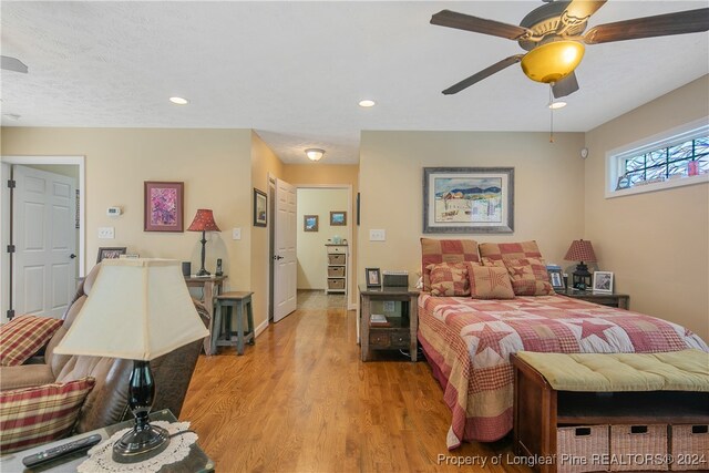 bedroom with ceiling fan and light hardwood / wood-style floors