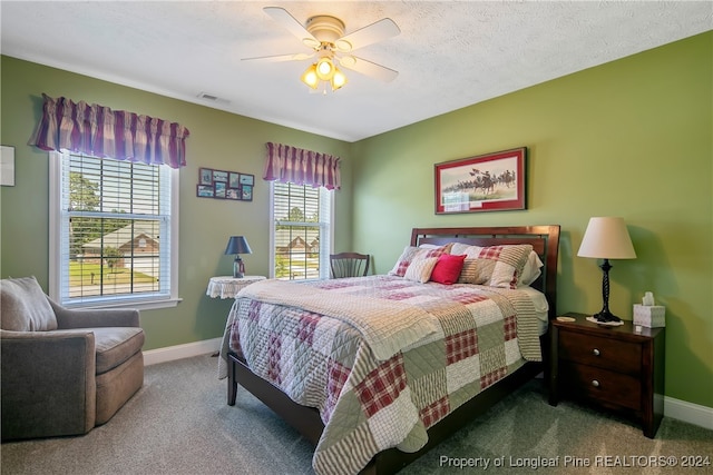 carpeted bedroom with a textured ceiling and ceiling fan