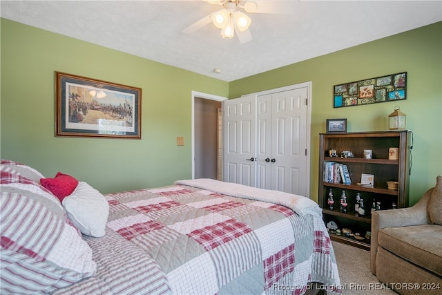 bedroom featuring carpet flooring, a textured ceiling, a closet, and ceiling fan