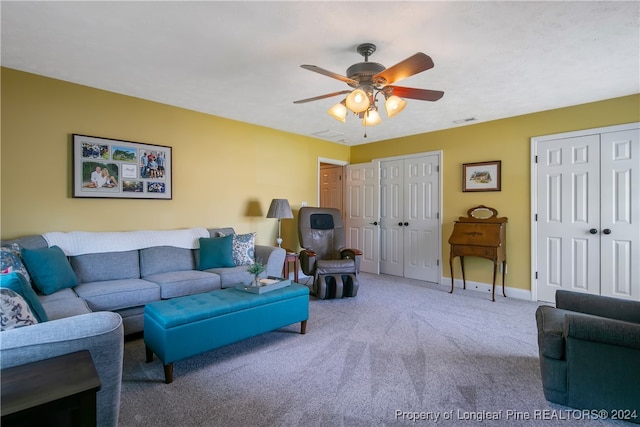 living room with ceiling fan and carpet floors