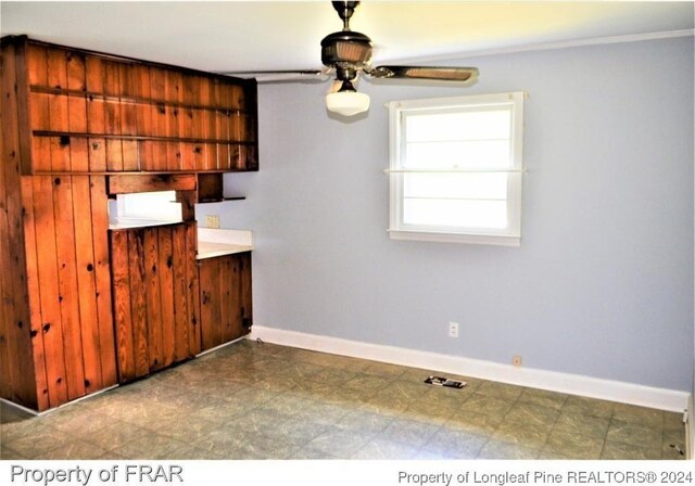 interior space with ceiling fan