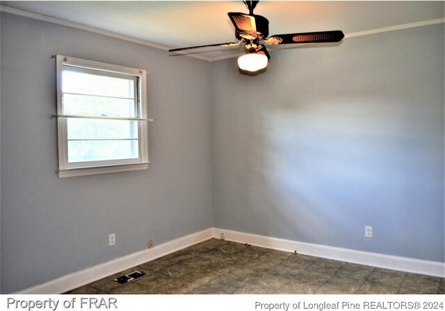 unfurnished room with ceiling fan and crown molding