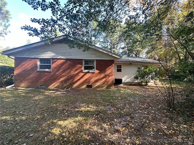 view of home's exterior featuring a lawn and central air condition unit