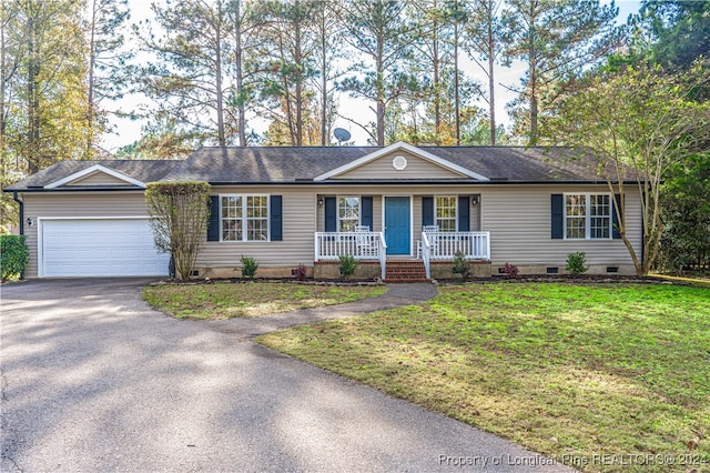 ranch-style home with a porch, a garage, and a front lawn