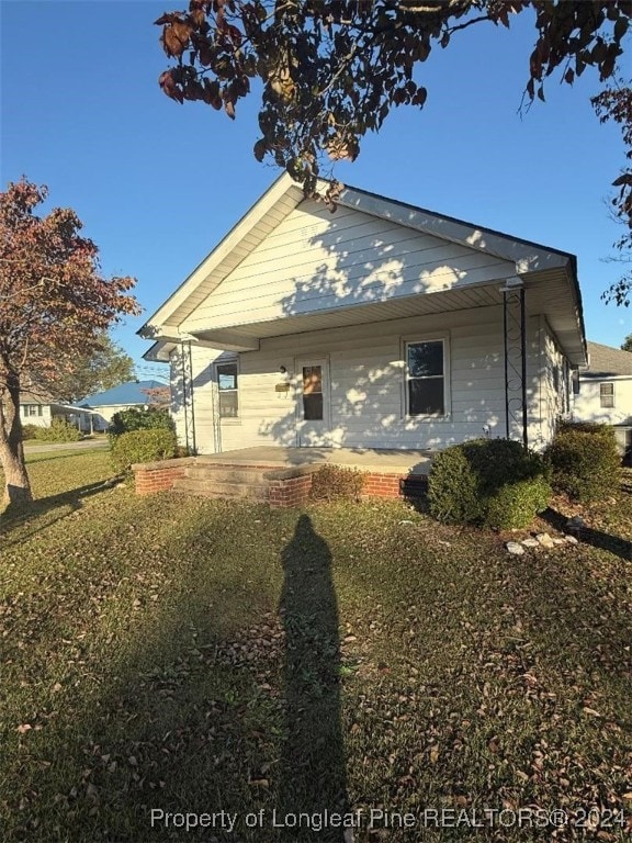 rear view of house with a yard