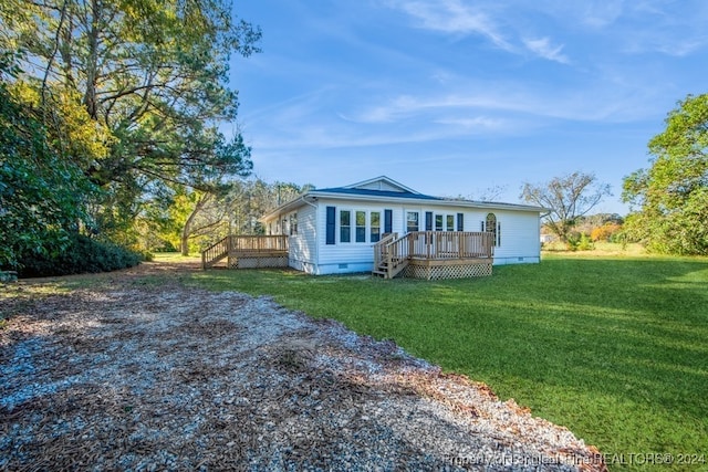 exterior space with a wooden deck and a front lawn