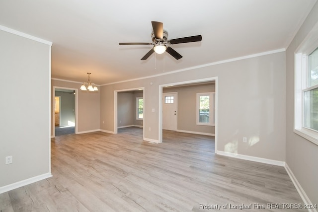 unfurnished room featuring ceiling fan with notable chandelier, light hardwood / wood-style floors, and crown molding