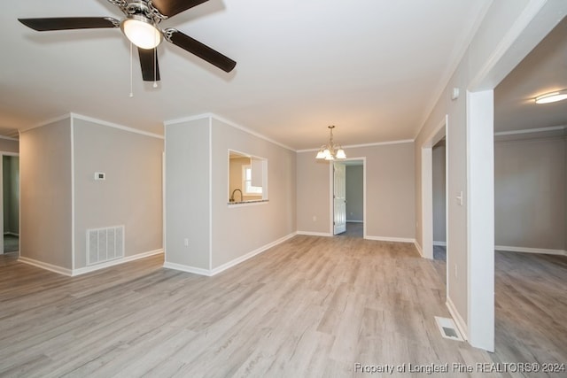 empty room featuring ceiling fan with notable chandelier, light hardwood / wood-style flooring, and ornamental molding