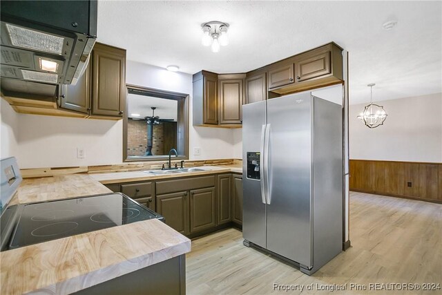 kitchen with sink, stove, stainless steel refrigerator with ice dispenser, and light wood-type flooring