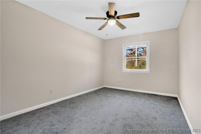 unfurnished room with ceiling fan and carpet floors