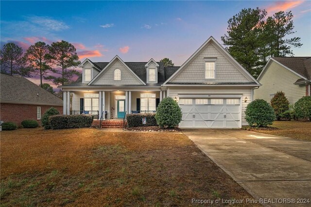 view of front of house featuring covered porch and a garage