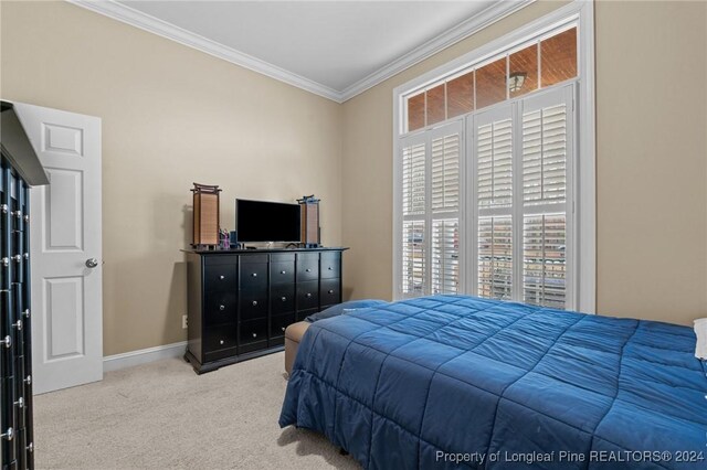 bedroom featuring ornamental molding, light carpet, and multiple windows