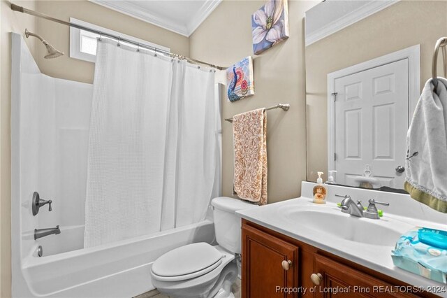 full bathroom featuring toilet, vanity, shower / tub combo, and ornamental molding