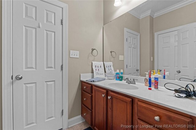 bathroom with vanity, tile patterned floors, and crown molding