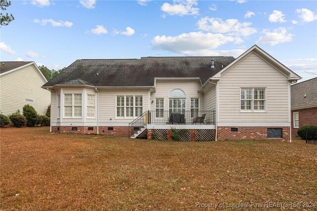 rear view of house with a yard and a deck