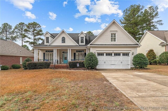 view of front of house featuring covered porch and a garage